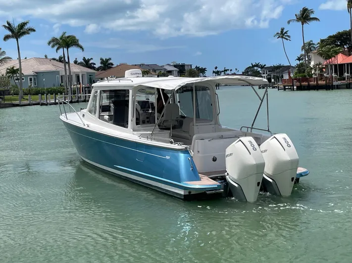  Yacht Photos Pics 2023 MJM 35z boat with twin outboard engines on a sunny day.