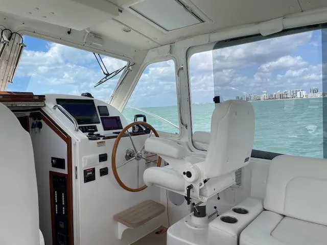  Yacht Photos Pics Interior of 2023 MJM 35z boat with helm, white seating, and ocean view.