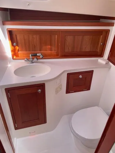  Yacht Photos Pics 2023 MJM 35z yacht bathroom with wooden cabinets and modern fixtures.