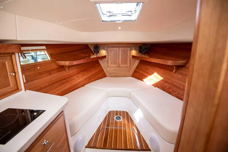  Yacht Photos Pics 2023 MJM 35z boat interior with wood paneling and white seating.