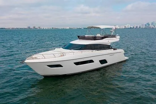  Yacht Photos Pics 2022 Ferretti Yachts 550 cruising on open water with city skyline in background.