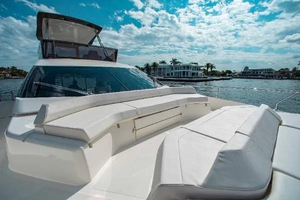  Yacht Photos Pics 2022 Ferretti Yachts 550 on water, showcasing luxurious deck seating under a bright sky.