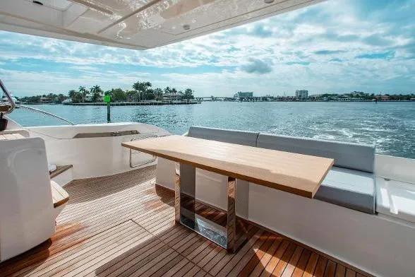  Yacht Photos Pics Luxurious 2022 Ferretti Yachts 550 deck with elegant seating and scenic ocean view.
