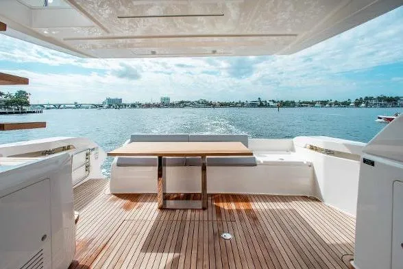  Yacht Photos Pics Luxurious 2022 Ferretti Yachts 550 deck with ocean view and elegant seating area.