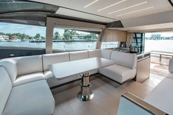  Yacht Photos Pics Luxurious interior of 2022 Ferretti Yachts 550 with elegant seating and waterfront view.