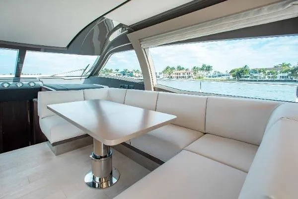  Yacht Photos Pics Luxurious interior of 2022 Ferretti Yachts 550 with elegant seating and scenic window view.