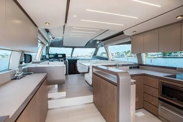  Yacht Photos Pics Luxurious interior of 2022 Ferretti Yachts 550, featuring modern kitchen and spacious seating area.