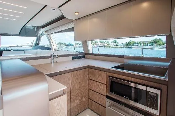  Yacht Photos Pics Modern kitchen interior of 2022 Ferretti Yachts 550 with sleek cabinetry and appliances.