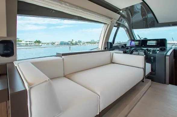  Yacht Photos Pics Luxurious interior of 2022 Ferretti Yachts 550 with modern seating and navigation controls.