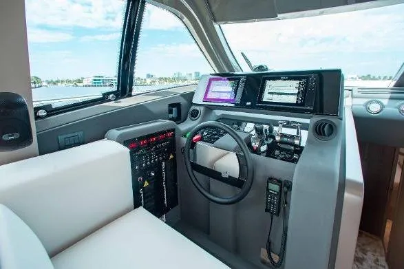  Yacht Photos Pics Cockpit of 2022 Ferretti Yachts 550 with modern navigation equipment and steering wheel.