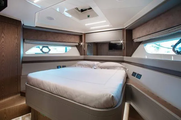  Yacht Photos Pics Luxurious cabin interior of 2022 Ferretti Yachts 550 with modern design and comfortable bedding.