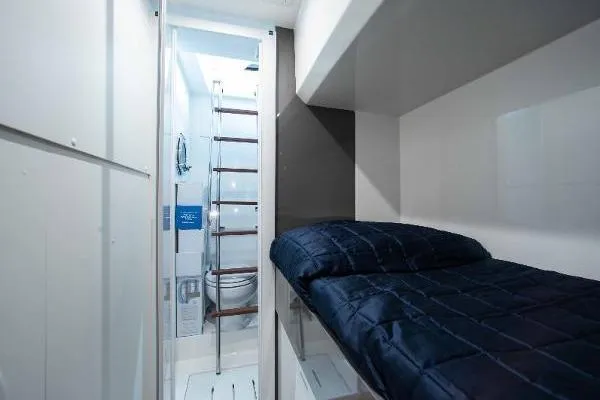  Yacht Photos Pics 2022 Ferretti Yachts 550 interior cabin with bunk bed and ladder access.