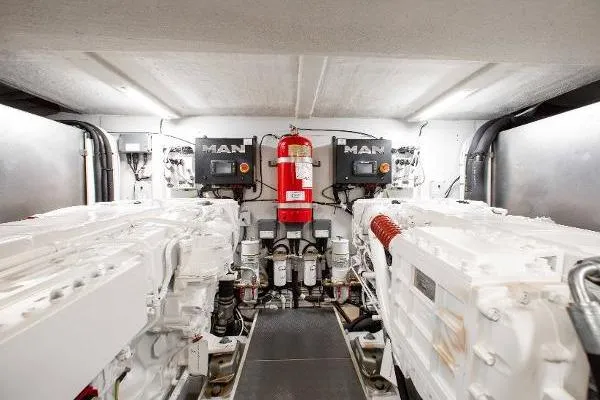  Yacht Photos Pics Engine room of 2022 Ferretti Yachts 550 with MAN engines and fire extinguisher.