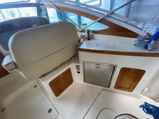  Yacht Photos Pics 2009 Hunt Yachts Harrier 29 interior with helm seat and storage compartments.