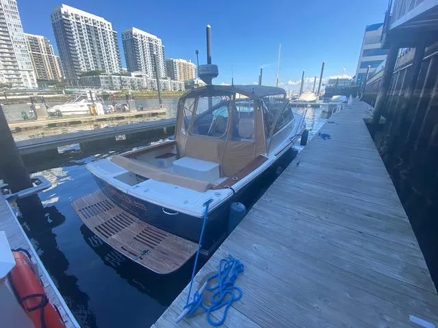  Yacht Photos Pics 2009 Hunt Yachts Harrier 29 docked at marina with cityscape background.