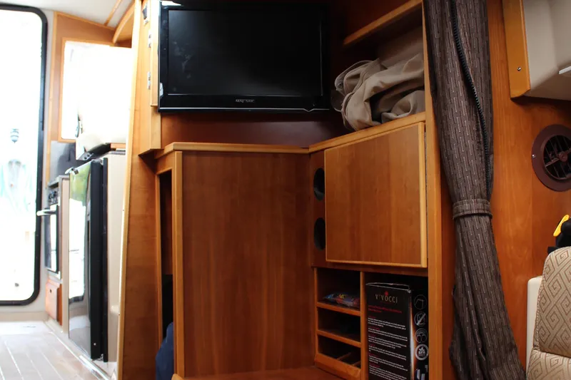 Shake N Bake Yacht Photos Pics Interior of 2013 Cutwater 28 LE with wooden cabinetry and mounted TV.