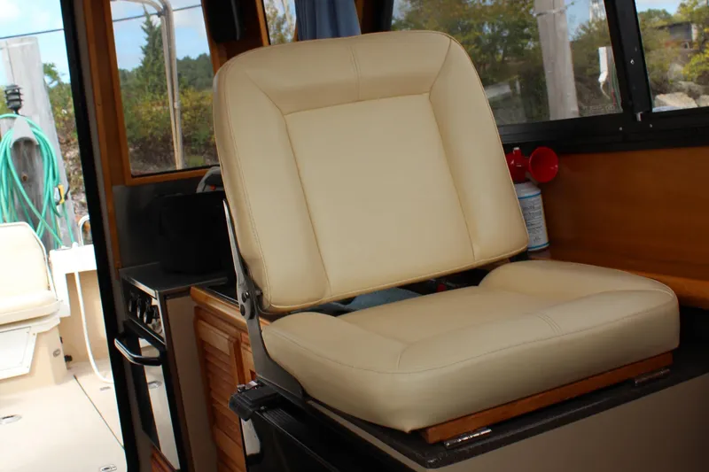 Shake N Bake Yacht Photos Pics Beige captain's chair inside a 2013 Cutwater 28 LE boat cabin.
