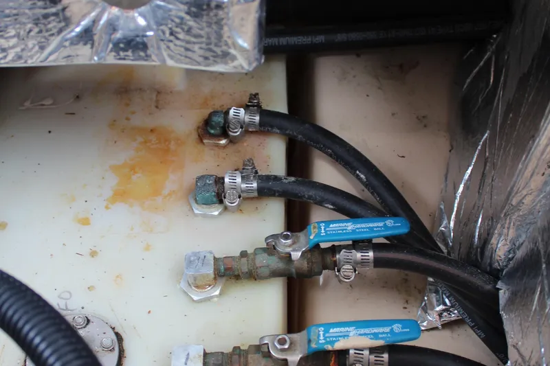 Shake N Bake Yacht Photos Pics Close-up of 2013 Cutwater 28 LE boat plumbing with hoses and valves.