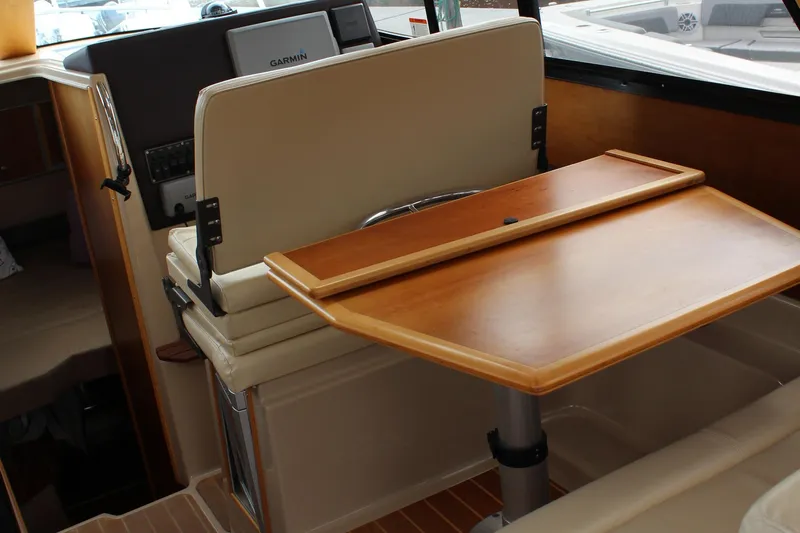 Shake N Bake Yacht Photos Pics 2013 Cutwater 28 LE interior with wooden table and Garmin navigation system.