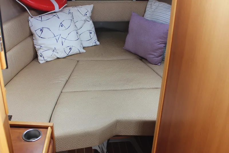 Shake N Bake Yacht Photos Pics Cozy cabin interior of 2013 Cutwater 28 LE with patterned cushions and pillows.