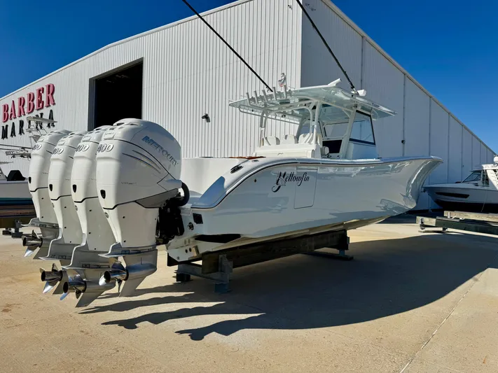 Yacht Photos Pics 2020 Yellowfin 42 Offshore boat with four engines, parked outside a marina.