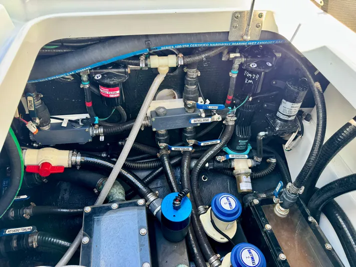  Yacht Photos Pics Engine compartment of a 2020 Yellowfin 42 Offshore boat with visible hoses and components.