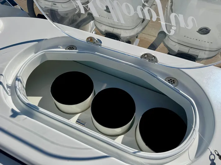  Yacht Photos Pics 2020 Yellowfin 42 Offshore boat with open storage compartment and three circular holders.