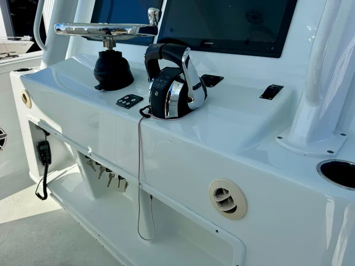  Yacht Photos Pics Control panel of a 2020 Yellowfin 42 Offshore boat with steering and electronics.