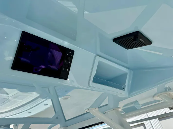  Yacht Photos Pics 2020 Yellowfin 42 Offshore boat interior ceiling with electronic panel and storage compartment.