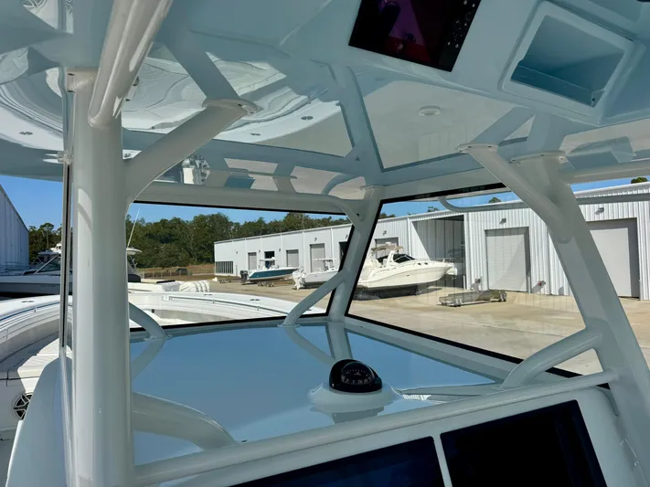  Yacht Photos Pics 2020 Yellowfin 42 Offshore boat interior with navigation equipment, docked near storage units.