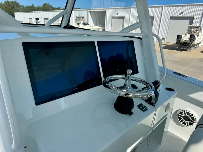  Yacht Photos Pics 2020 Yellowfin 42 Offshore boat helm with dual screens and steering wheel.
