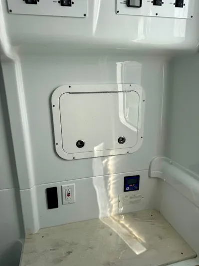  Yacht Photos Pics 2020 Yellowfin 42 Offshore boat interior with control panel and storage compartment.