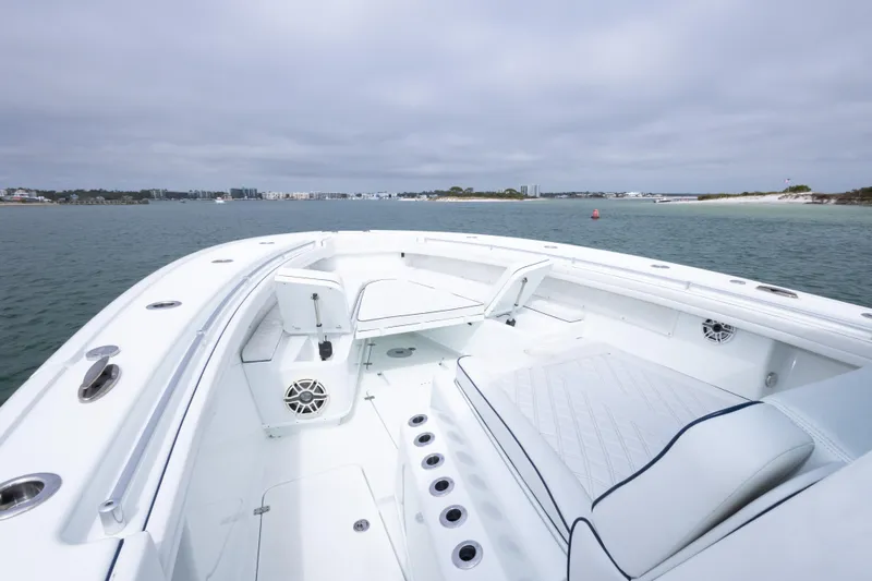  Yacht Photos Pics 2020 Yellowfin 42 Offshore boat interior with white seating, on calm water.