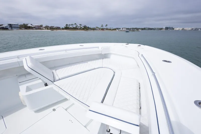  Yacht Photos Pics 2020 Yellowfin 42 Offshore boat with spacious white seating area on calm water.