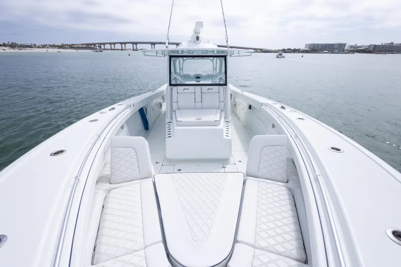  Yacht Photos Pics 2020 Yellowfin 42 Offshore boat with luxurious seating on calm waters.