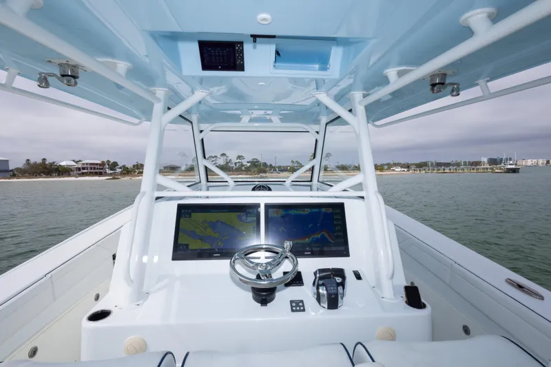  Yacht Photos Pics 2020 Yellowfin 42 Offshore boat helm with dual navigation screens on calm water.