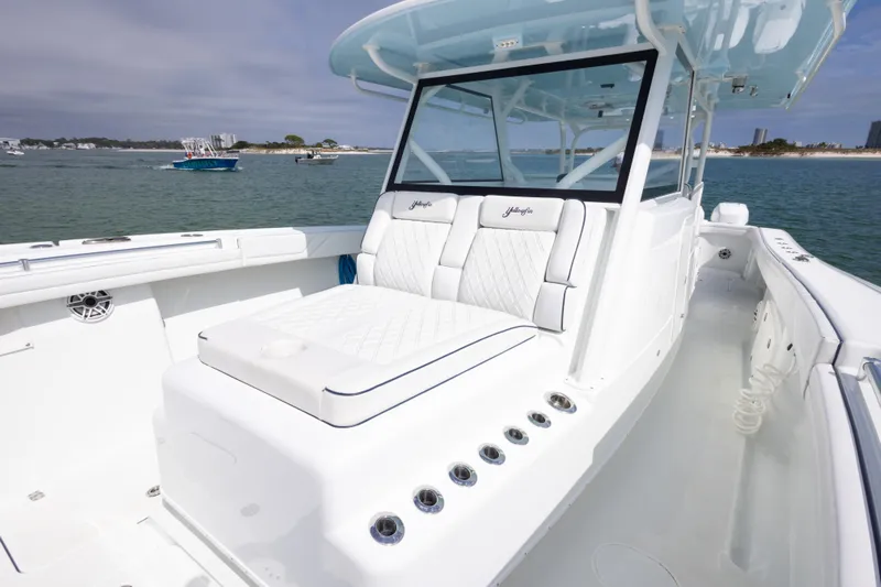  Yacht Photos Pics 2020 Yellowfin 42 Offshore boat with luxurious seating, cruising on a calm sea.