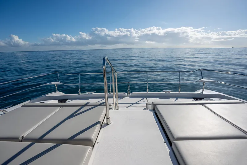  Yacht Photos Pics Aquila 54 Yacht 2025 deck with ocean view under clear blue sky.