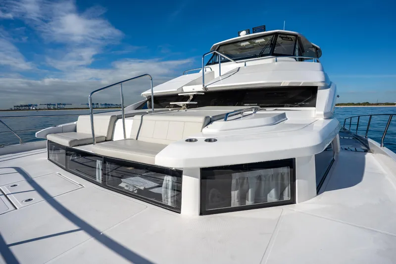  Yacht Photos Pics 2025 Aquila 54 Yacht on calm water, showcasing sleek design and spacious deck.