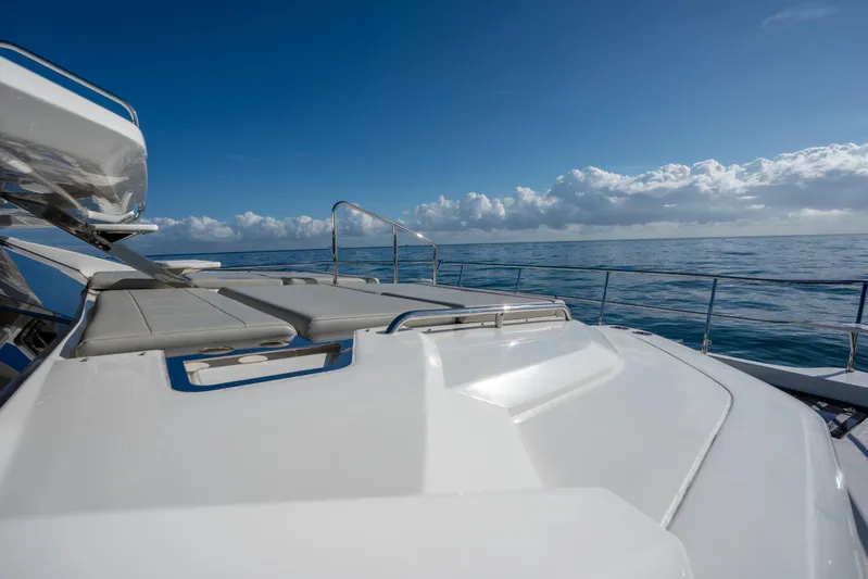  Yacht Photos Pics 2025 Aquila 54 Yacht deck with ocean view under clear blue sky.