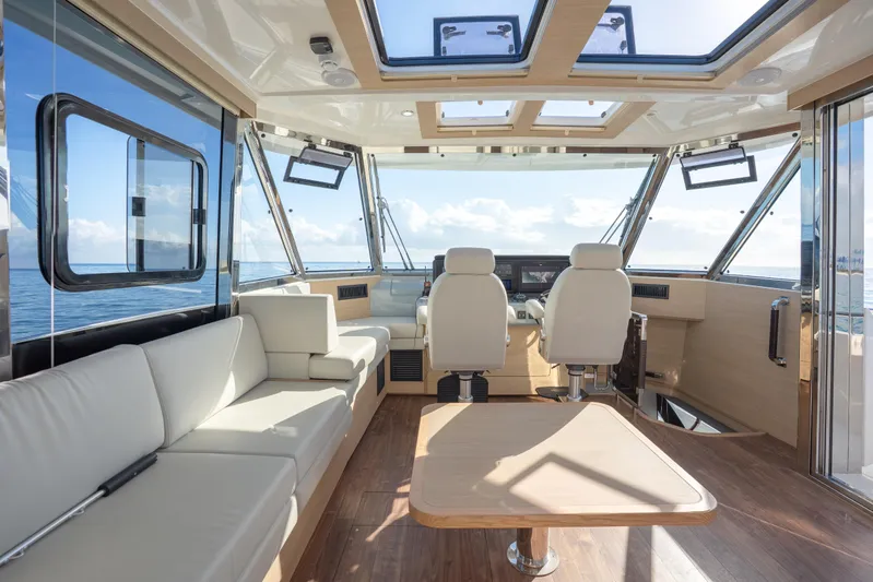  Yacht Photos Pics Luxurious interior of 2025 Aquila 54 Yacht with panoramic windows and elegant seating.