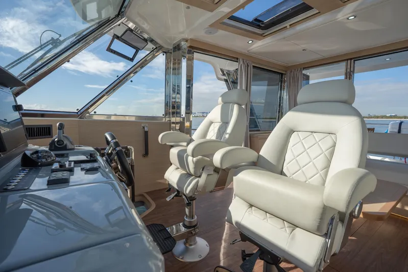  Yacht Photos Pics Luxurious helm of 2025 Aquila 54 Yacht with plush seating and advanced controls.