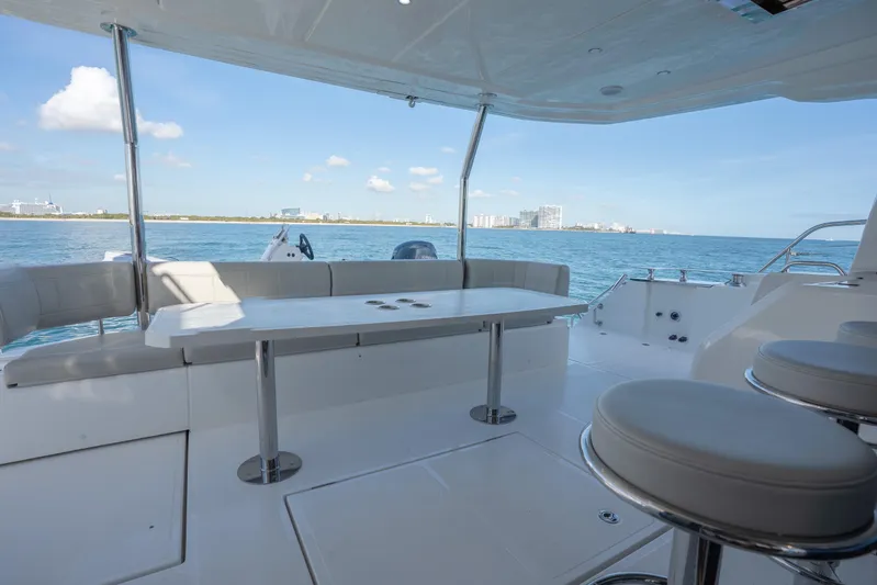  Yacht Photos Pics Luxury deck of 2025 Aquila 54 Yacht with ocean view and seating area.