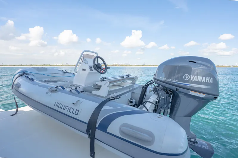  Yacht Photos Pics Highfield inflatable boat with Yamaha engine on Aquila 54 Yacht, 2025 model, in serene waters.
