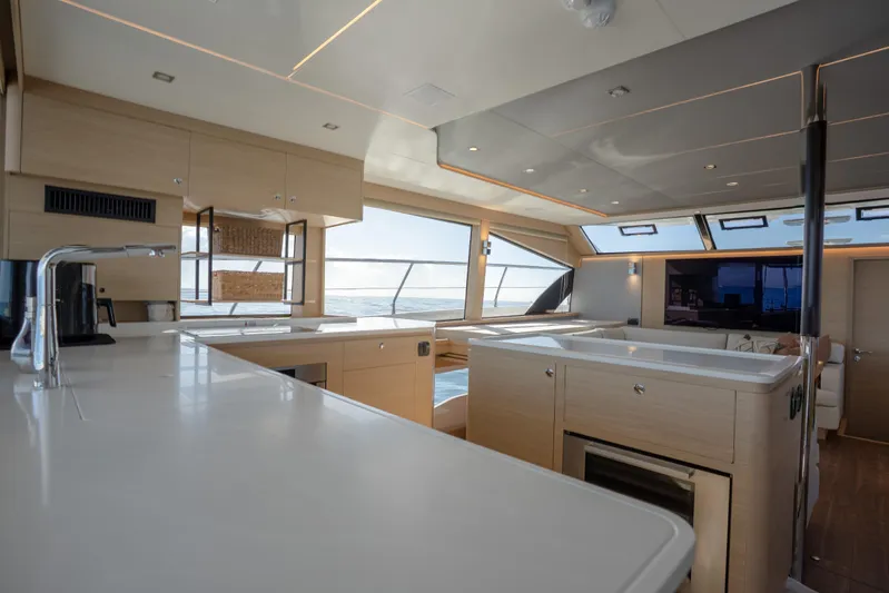  Yacht Photos Pics Luxurious interior of 2025 Aquila 54 Yacht with modern kitchen and panoramic windows.