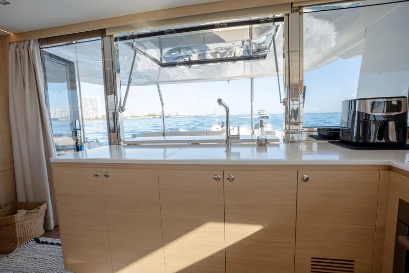  Yacht Photos Pics Luxurious interior of 2025 Aquila 54 Yacht with ocean view through large windows.