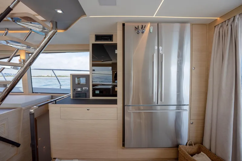  Yacht Photos Pics Modern kitchen interior on 2025 Aquila 54 Yacht, featuring stainless steel appliances and ocean view.