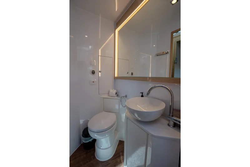  Yacht Photos Pics Modern bathroom interior on 2025 Aquila 54 Yacht with sleek fixtures and ambient lighting.