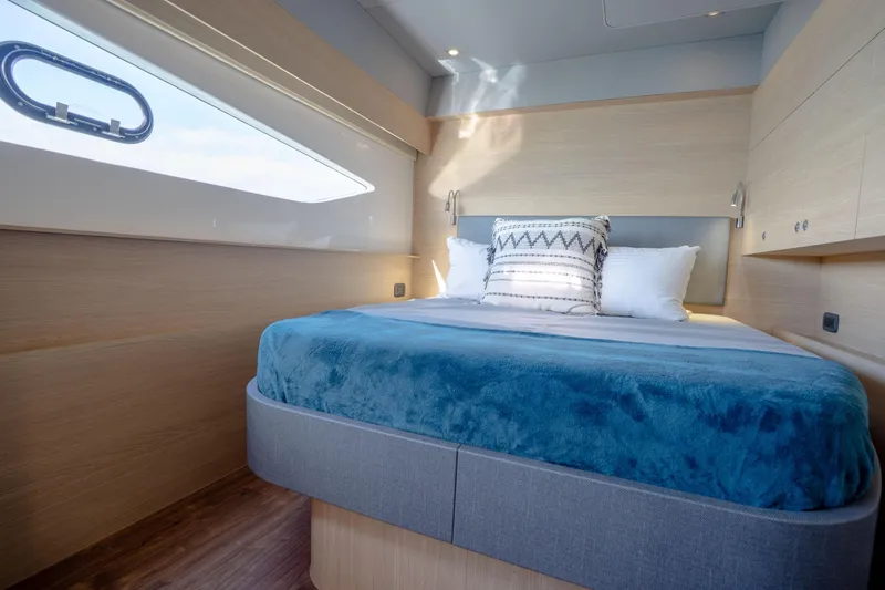  Yacht Photos Pics Luxurious bedroom interior of 2025 Aquila 54 Yacht with modern design and cozy bedding.