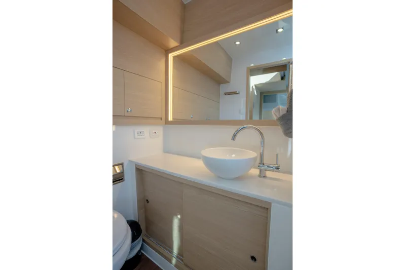  Yacht Photos Pics Modern bathroom interior on 2025 Aquila 54 Yacht with sleek sink and mirror.